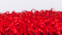 L'échantillon d'une dalle WARCO en gazon artificiel laminé en couleur rouge.